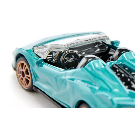 Miniatura de Lamborghini Sián Roadster turquesa con llantas doradas y techo abierto.
