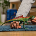 Dinosaurio Concavenator de Schleich con mandíbula articulada y joroba roja de juguete.