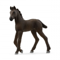 Potro frisón de juguete Schleich con pelaje negro azabache en postura curiosa.